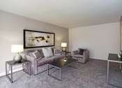 Thumbnail 8 of 25 - a living room with a couch and chairs and a coffee table