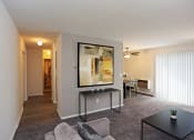 Thumbnail 9 of 25 - a living room with a couch and a coffee table in front of a large window