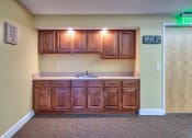 Thumbnail 8 of 14 - an empty kitchen with wooden cabinets and a sink