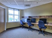 Thumbnail 9 of 14 - a large office with three desks with computers and chairs