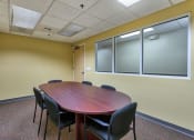 Thumbnail 12 of 14 - a conference room with a wooden table and chairs