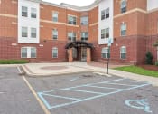 Thumbnail 1 of 14 - the entrance to a brick building with a handicapped parking lot