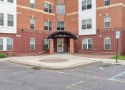 Thumbnail 4 of 14 - the entrance to a brick building with a sidewalk in front of it