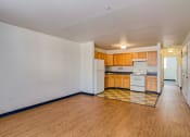 Thumbnail 10 of 11 - a kitchen with wood floors and white appliances