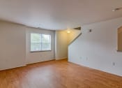Thumbnail 8 of 11 - the living room and dining room of an empty house with wood flooring