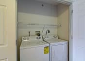 Thumbnail 1 of 11 - a white washer and dryer in a laundry room