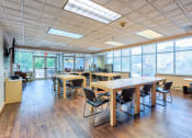 Thumbnail 7 of 10 - a large room with tables and chairs in a classroom