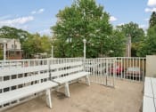 Thumbnail 5 of 10 - the terrace of a building with benches and a white fence