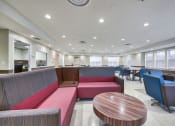 Thumbnail 9 of 15 - a lounge area with couches and chairs and tables