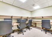 Thumbnail 8 of 15 - a large room with desks and chairs in it