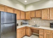 Thumbnail 14 of 15 - a kitchen with a refrigerator microwave and sink