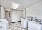 Thumbnail 11 of 15 - a kitchen with white appliances and a checkered floor