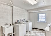 Thumbnail 15 of 15 - a laundry room with washing machines and sinks and a window