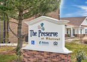 Thumbnail 3 of 15 - the preserve at wheatland sign in front of a building