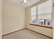 Thumbnail 6 of 50 - A room with a window and a ceiling fan.