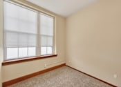 Thumbnail 10 of 50 - A room with a window and carpeted floor.