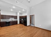 Thumbnail 2 of 50 - A kitchen with dark wood cabinets and a black fridge.