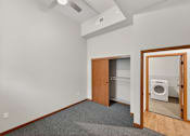 Thumbnail 27 of 50 - A room with a washing machine in it.