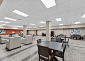 Thumbnail 38 of 50 - A large room with tables and chairs.
