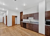 Thumbnail 8 of 50 - A kitchen with brown cabinets and a marble countertop.