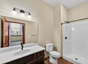 Thumbnail 18 of 50 - A bathroom with a white sink, toilet, and bathtub.