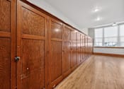 Thumbnail 21 of 50 - A row of wooden doors in a room.