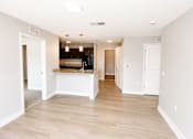 Thumbnail 3 of 28 - A kitchen with white cabinets and a wooden floor.