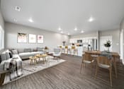 Thumbnail 18 of 51 - A modern living room with a grey sofa, wooden chairs, and a dining table.