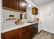 Thumbnail 50 of 74 - A kitchen with wooden cabinets and a white refrigerator.