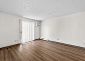 Thumbnail 60 of 74 - A room with wooden floors and a white door.