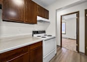 Thumbnail 61 of 74 - A kitchen with white appliances and wooden cabinets.