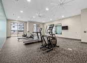 Thumbnail 11 of 52 - A spacious gym with treadmills and elliptical machines.