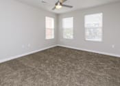 Thumbnail 3 of 43 - A room with a ceiling fan and carpeted floor.at 5Fifty5, Des Moines Iowa  