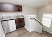 Thumbnail 13 of 43 - a kitchen with a sink and a bar and a staircase at 5Fifty5, Iowa  