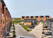 Thumbnail 19 of 43 - a row of new apartment buildings on a city street at 5Fifty5, Des Moines Iowa  