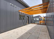 Thumbnail 21 of 43 - a large patio with a wooden roof on the side of a building at 5Fifty5, Iowa  