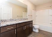 Thumbnail 9 of 43 - a bathroom with a large mirror and a toilet and a shower at 5Fifty5, Des Moines  