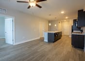 Thumbnail 6 of 65 - A spacious room with a ceiling fan and lighting fixtures.