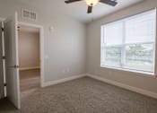 Thumbnail 16 of 65 - A room with a ceiling fan and a window with blinds.