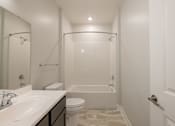 Thumbnail 5 of 65 - A white bathroom with a sink, toilet, and bathtub.