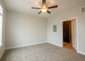 Thumbnail 41 of 65 - A room with a ceiling fan and a door.