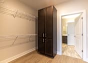 Thumbnail 34 of 65 - A large wooden wardrobe with a mirror above it.