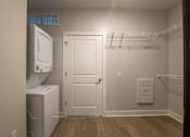 Thumbnail 37 of 65 - A small laundry room with a washer and dryer.