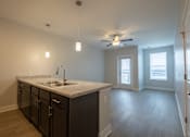 Thumbnail 36 of 65 - A kitchen with a marble countertop and a ceiling fan.