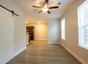 Thumbnail 27 of 65 - A room with a ceiling fan and a door.