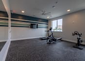 Thumbnail 62 of 65 - A room with a grey carpet and a ceiling fan.