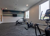Thumbnail 56 of 65 - A gym with treadmills and a television on the wall.