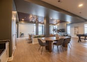 Thumbnail 59 of 65 - A modern kitchen with a dining table and chairs.