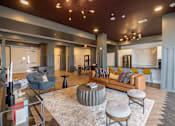Thumbnail 65 of 65 - A living room with a grey rug and a round table in the middle.