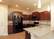 Thumbnail 3 of 14 - Fully Equipped Kitchen With Modern Appliances at 7th Street Brownstones, Indigo Living, IA, 50309